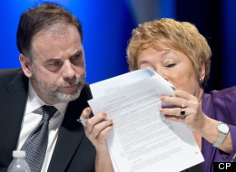 Quebec Premier Pauline Marois and Education Minister Pierre Duchesne read a document during the education summit Monday, February 25, 2013 in Montreal. THE CANADIAN PRESS/Paul Chiasson