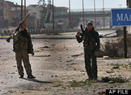 In this Tuesday Feb. 26, 2013 file photo, Free Syrian Army fighters patrol at the Aleppo-Damascus highway which is controlled by the rebels to cut supply for the Syrian army forces, at the front line of Maaret al-Numan town, in Idlib province, Syria. (AP Photo/Hussein Malla, File)