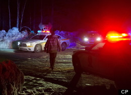 Police vehicles block a road just outside the town of Chertsey, Que., Sunday, March 17, 2013, during a search for escaped prisoners. THE CANADIAN PRESS/Graham Hughes