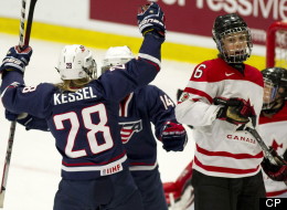 Team Canada's Rebecca Johnston looks over as Team USA's Amanda Kessel (28) and Brianna Decker celebrate a goal by teammate Kendall Coyne during first period gold medal hockey action at the World Women's Ice Hockey Championships Saturday, April 14, 2012 in Burlington, Vermont. THE CANADIAN PRESS/Paul Chiasson