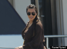 Kim Kardashian showed off her pregnancy curves while in Greece on April 27.