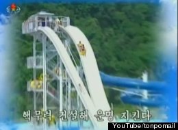 A still from North Korea's latest propaganda video shows people on a waterslide. The video also features images of tanks, missiles and exploding bombs. (credit: YouTube/tonpomail)