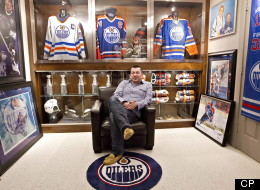 Shawn Chaulk poses with his collection of Wayne Gretzky memorabilia in Fort McMurray, Alta., on Wednesday April 16, 2013. Chaulk will have a variety of these items for sale at an upcoming auction. Chaulk's Gretzky collection goes on sale in an online auction on Friday. THE CANADIAN PRESS/Jason Franson