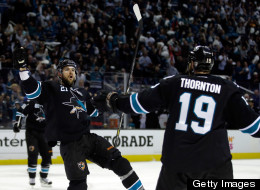 T.J. Galiardi #21 of the San Jose Sharks is congratulated by Joe Thornton #19 after he scored a goal in the second period of their game against the Los Angeles Kings during Game Six of the Western Conference Semifinals during the 2013 Stanley Cup Playoffs at HP Pavilion on May 26, 2013 in San Jose, California.