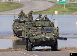 The Canadian Army makes its presence felt as it arrives to provide assistance in the ravaged town of High River. (CP)
