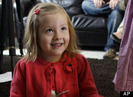 Coy Mathis sits with a book at her home in Fountain, Colo., Monday Feb. 25, 2013. (AP Photo/Brennan Linsley)