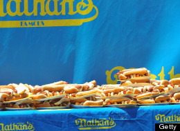 Joey Chestnut (L) of San Jose, California celebrates winning the annual International July Fourth Hot Dog Eating Contest by holding a plate of 66 hot dogs and buns with an unidentified official on July 4, 2007, at the original Nathan's Famous restaurant in the Coney Island section of Brooklyn, NY. Chestnut won by eating 66 hot dogs in 12 minutes. AFP PHOTO/Stan HONDA