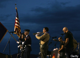 PRESCOTT, AZ - JULY 02: A member of the Boy Scouts of America plays a bugle tribute as the colors are posted at a candlelight vigil in honor of the 19 fallen firefighters at Prescott High School on July 2, 2013 in Prescott, Arizona. 19 Granite Mountain Interagency Hotshot Crew firefighters died battling a fast-moving wildfire near Yarnell, AZ on Sunday. (Photo by Christian Petersen/Getty Images)