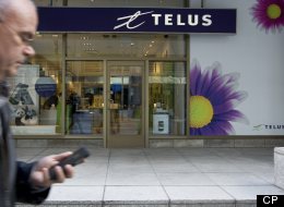 A cell phone user passing a Telus store in Toronto on Monday, April 1, 2013. A long-simmering cold war between Canada’s big telecom firms and consumer advocates has turned into a hot war over the contentious subject of whether or not Canadians are being ripped off on their wireless bills. (Peter Power / The Globe and Mail)