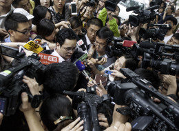 Lan He (C), legal advisor for the family of Li Tianyi -- the son of a Chinese singer charged with rape, according to state media -- is surrounded by a group of journalists before the trial of Li's case in Haidian court in Beijing on August 28, 2013. Li Tianyi, the son of a Chinese general Li Shuangjiang, went on trial on August 28 over his involvement in an alleged gang rape, state media said, in a case that sparked public outrage. CHINA OUT AFP PHOTO (Photo credit should read STR/A