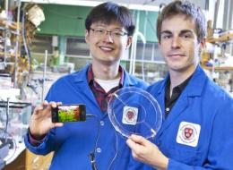 Jeong-Yun Sun (left) and Christoph Keplinger (right), Harvard University, demonstrate their transparent ionic speaker.