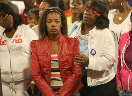 Semehca Nunn (C) is comforted during a prayer service at New Beginnings Church for the victims of Thursday's mass shooting on September 20, 2013 in Chicago, Illinois. Nunn's 3-year-old grandson Deonta Howard was one of thirteen people wounded when a gunman opened fire yesterday on a crowd of people playing basketball in a park in the Back of the Yards neighborhood in the city's Southside. (Photo by Scott Olson/Getty Images)
