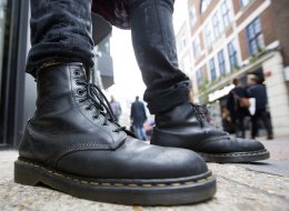 A pedestrian wearing Dr. Martens boots poses for a photograph outside the footwear company's store in Convent Garden in London, U.K. (Simon Dawson/Bloomberg via Getty Images)