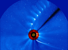 Comet ISON comes in from the bottom right and moves out toward the upper right, getting fainter and fainter, in this time-lapse image from the ESA/NASA Solar and Heliospheric Observatory. The image of the sun at the center is from NASA's Solar Dynamics Observatory.