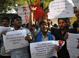 Members of The All India Students Federation (AISF) shout slogans and wave placards during a protest in front of the US consulate in Hyderabad on December 19, 2013, following the arrest of New York-based Indian diplomat Devyani Khobragade. (STRDEL/AFP/Getty I