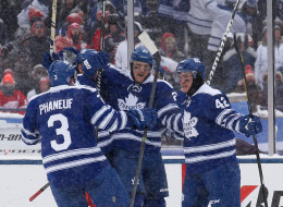 James van Riemsdyk #21 of the Toronto Maple Leafs celebrates his second-period goal against the Detroit Red Wings with teammates Dion Phaneuf #3 and Tyler Bozak #42 during the 2014 Bridgestone NHL Winter Classic at Michigan Stadium on Jan. 1 in Ann Arbor, Mich.