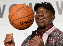 Former NBA star Dennis Rodman plays with a basketball during a press conference in Tokyo on October 25, 2013.