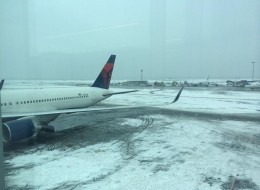 A plane from Toronto landed safely at John F. Kennedy International Airport on Sunday before sliding into snow as it turned onto a taxiway. The airport temporarily suspended flights from taking off and landing because of icy runways. (Laurie Kopec/ Twitter)