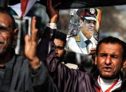 Egyptian voters wait outside a polling station to cast their votes for the constitutional referendum, Giza, Egypt, January 15, 2014. (Mohamed Hossam/Anadolu Agency/Getty Images)