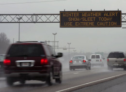 A travel advisory sign along I-85 South warns drivers of hazardous driving conditions as a winter storm approaches on February 11, 2014 in Atlanta, Georgia.