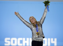 Women?s snowboard slopestyle gold medalist Jamie Anderson of the United States stands on the podium during the medals ceremony at the 2014 Winter Olympics, Sunday, Feb. 9, 2014, in Sochi, Russia. (AP Photo/David Goldman)