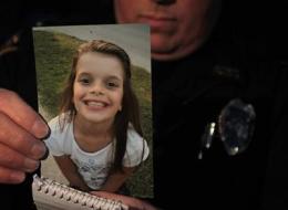 Lt. Robert Pitts holds the photo of Hailey Owens, 10, on Tuesday, Feb. 19, 2014 in Springfield, Mo. Woods was charged Wednesday with first-degree murder in the death of a 10-year-old girl. A body believed to be that of Hailey Owens was found Wednesday at the home owned by Wood, Police Chief Paul Williams said at a news conference. Official confirmation won't occur until after an autopsy, but Police Chief Paul Williams said