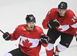 Jamie Benn scores the first goal of the Canada vs. USA Olympic hockey game and celebrates with Corey Perry. (Getty)