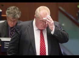 Toronto Mayor Rob Ford wipes his brow in the council chamber as councillors look to pass motions to limit his powers on Monday November 18, 2013. THE CANADIAN PRESS/Chris Young