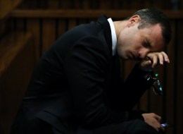 South African Paralympic track star Oscar Pistorius reacts during his trial for the murder of his girlfriend Reeva Steenkamp, at the North Gauteng High Court in Pretoria, on April 7, 2014. An emotional Oscar Pistorius took the stand as a witness in his defence on April 7, fighting through tears to apologise to the family of his girlfriend Reeva Steenkamp for killing her on Valentine's Day 2013. AFP PHOTO / POOL / THEMBA HADEBE (Photo credit should read THEMBA HADEBE/AFP/Getty Images)