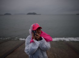 A relative waits on a pier in Jindo on April 17, 2014, as the frantic search for nearly 300 people, most of them schoolchildren, missing after a South Korean ferry capsized extended into a second day, as distraught relatives maintained an agonising vigil on shore. Heart-wrenching messages of fear, love and despair, sent by high school students from a sinking South Korean ferry added extra emotional weight on April 17 to a tragedy that has stunned the entire nation. AFP PHOTO / ED JONES