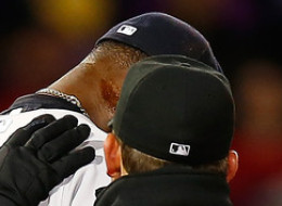 Home plate umpire Gerry Davis checks out a substance on the neck of Michael Pineda #35 of the New York Yankees before throwing him out of the game in the second inning against the Boston Red Sox during the game at Fenway Park on April 23, 2014 in Boston, Massachusetts. (Photo by Jared Wickerham/Getty Images)