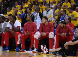 Los Angeles Clippers players sit on the bench wearing their warm-up tops inside out against the Golden State Warriors in Game Four of the Western Conference Quarterfinals during the 2014 NBA Playoffs at ORACLE Arena on April 27, 2014 in Oakland, California.