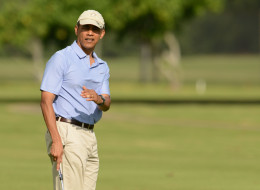 President Barack Obama lines up his putt on the second green while golfing with the Prime MInister of New Zealand John Key at Marine Corps Base Hawaii's Kaneohe. (Cory Lum-Pool/Getty Images)