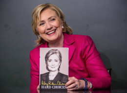 Former Secretary of State Hillary Clinton poses with her new book, 'Hard Choices' during a book signing at a Barnes & Noble on June 10, 2014 in New York City. (Photo by Andrew Burton/Getty Images)