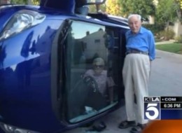 Benjamin Neufeld stands next to his wife Elizabeth who's trapped in their car after flipping it near their Los Angeles home. Elizabeth was unharmed.