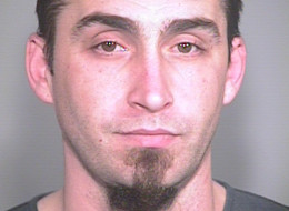 This image released by the Portland, Ore., Police Bureau, shows David Kalac, 33, who police say is a suspect in the killing of a woman in Port Orchard, Wash., where graphic photos of the victim's body were posted online hours before before police found the body. ( AP Photo/Portland Police Bureau)