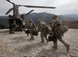 KORENGAL VALLEY, AFGHANISTAN - OCTOBER 27: U.S. soldiers board an Army Chinook transport helicopter after it brought fresh soldiers and supplies to the Korengal Outpost on October 27, 2008 in the Korengal Valley, Afghanistan. The military spends huge effort and money to fly in supplies to soldiers of the 1-26 Infantry based in the Korengal Valley, site of some of the fiercest fighting of the Afghan war. The unpaved road into the remote area is bad and will become more treacherous with the onse