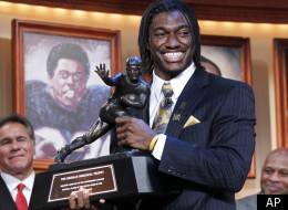 Robert Griffin III, of Baylor University, holds the Heisman Trophy award after being named the winner, Saturday, Dec. 10, 2011, in New York. (AP Photo/Kelly Kline, pool)