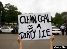 A protester holds up a placard as environmentalists and other protesters rallying outside the White House in Washington, DC, September 27, 2010, urge the Obama administration to end mountain top mining. (JIM WATSON/AFP/Getty Images)