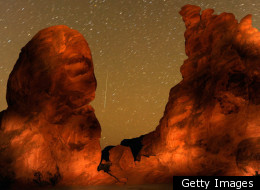 A Geminid meteor streaks between peaks of the Seven Sisters rock formation early December 14, 2010 in the Valley of Fire State Park in Nevada