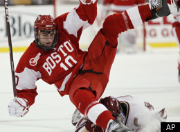 Boston University's Corey Trivino (10) is upended by Boston College's Brian Gibbons during the first period of a Beanpot college hockey tournament game in Boston on Monday, Feb. 7, 2011. (AP Photo/Winslow Townson)