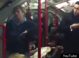 The man continues to dance, oblivious to the fact a fellow passenger (right) is plotted to throw him off the train