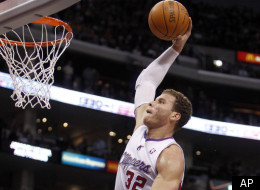Los Angeles Clippers forward Blake Griffin (32) prepares to dunk the ball as Los Angeles Lakers' Andrew Bynum, lower left, Devin Eubanks (3) and Derek Fisher, back right, watch during the first half of an NBA preseason basketball game in Los Angeles, Wednesday, Dec. 21, 2011. (AP Photo/Alex Gallardo)