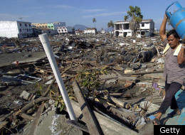 An Acehnese man salvages a can of propane gas from his destroyed home in Banda Aceh, 30 December 2004, as the clean up continues following the earthquake and tsunami that hit Aceh province 26 December. BAY ISMOYO/AFP/Getty Images)