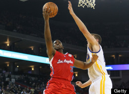 OAKLAND, CA - DECEMBER 25: Chris Paul #3 of the Los Angeles Clippers shoots over David Lee #10 of the Golden State Warriors during the season opener at Oracle Arena on December 25, 2011 in Oakland,