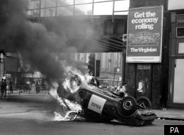 A police car in flames after riots in Brixton which Thatcher feared could ruin the Royal wedding of Diana and Charles