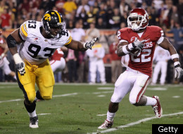 TEMPE, AZ - DECEMBER 30: Runningback Roy Finch #22 of the Oklahoma Sooners rushes the football against defensive lineman Mike Daniels #93 of the Iowa Hawkeyes during the Insight Bowl at Sun Devil Stadium on December 30, 2011 in Tempe, Arizona. (Photo by Christian Petersen/Getty Images)