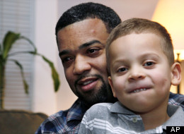 In this Dec. 27, 2011 photo, Damon Brown sits with his son Julian, 5, at their home in Seattle. Damon Brown found a kidney on Facebook after telling his story on a special page the Seattle dad created under the name, “Damon Kidney.” His friends and family forwarded the link to everyone they knew and on Jan. 3, a woman his wife has known for years but not someone they consider a close family friend, will be giving him a kidney. (AP Photo/Elaine Thompson)