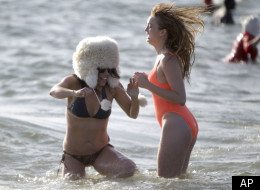 Participants in the annual New Year's Day Coney Island Polar Bear Club swim react to the cold water in New York, Sunday, Jan. 1, 2012. (AP Photo/Seth Wenig)