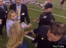 ESPN reporter Holly Rowe shoves another reporter to get an interview with Michigan coach Brady Hoke.